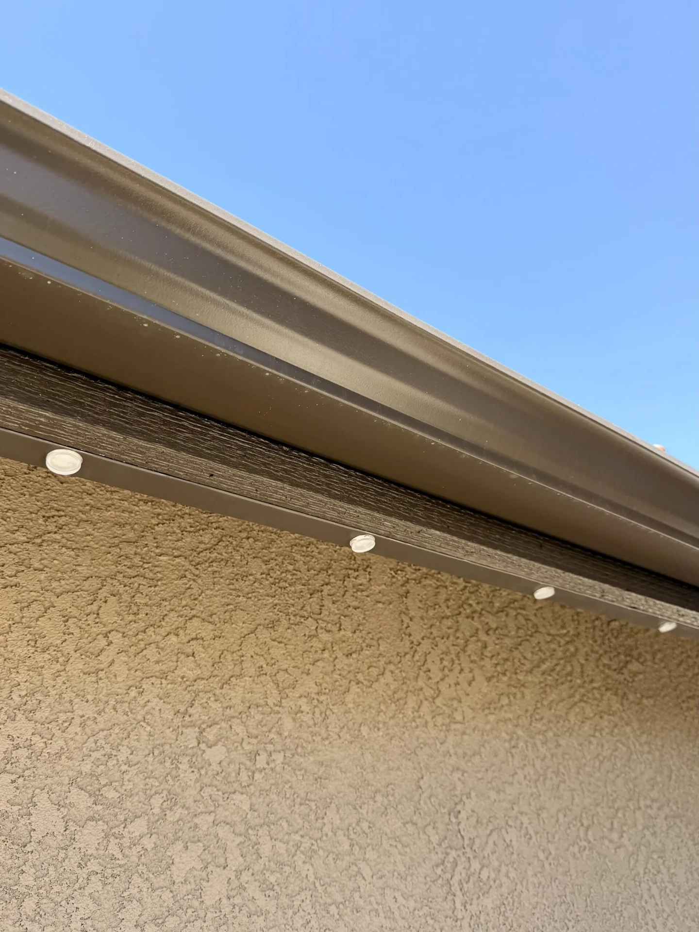 Color-matched aluminum channel blending into the fascia board