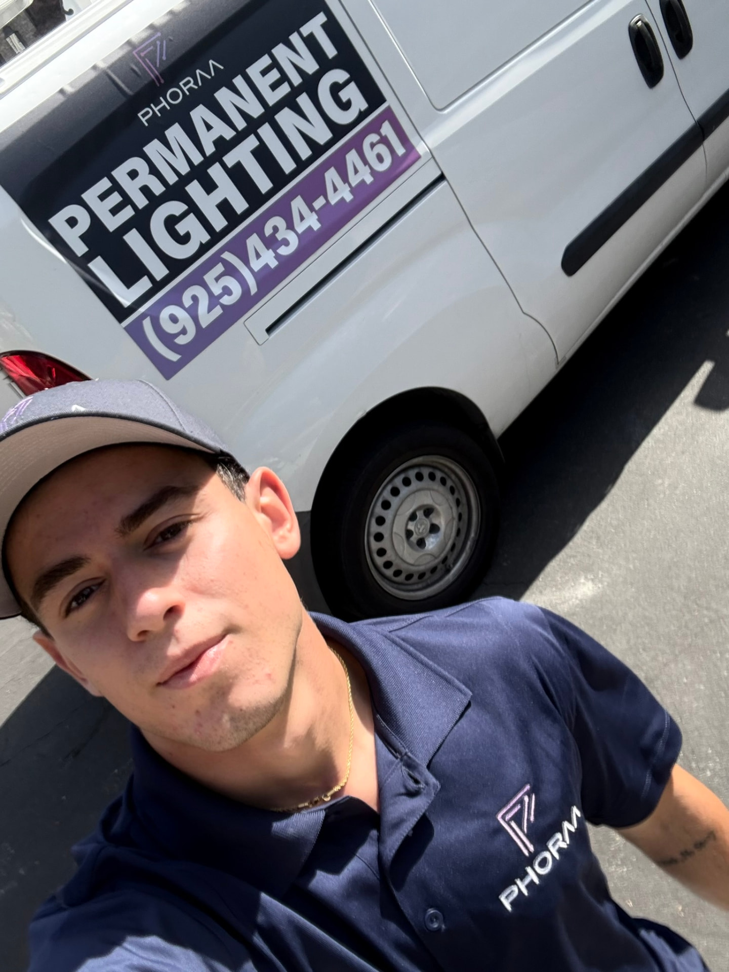 Krasi, founder of Phoraa Lighting, beside the company van in the Bay Area