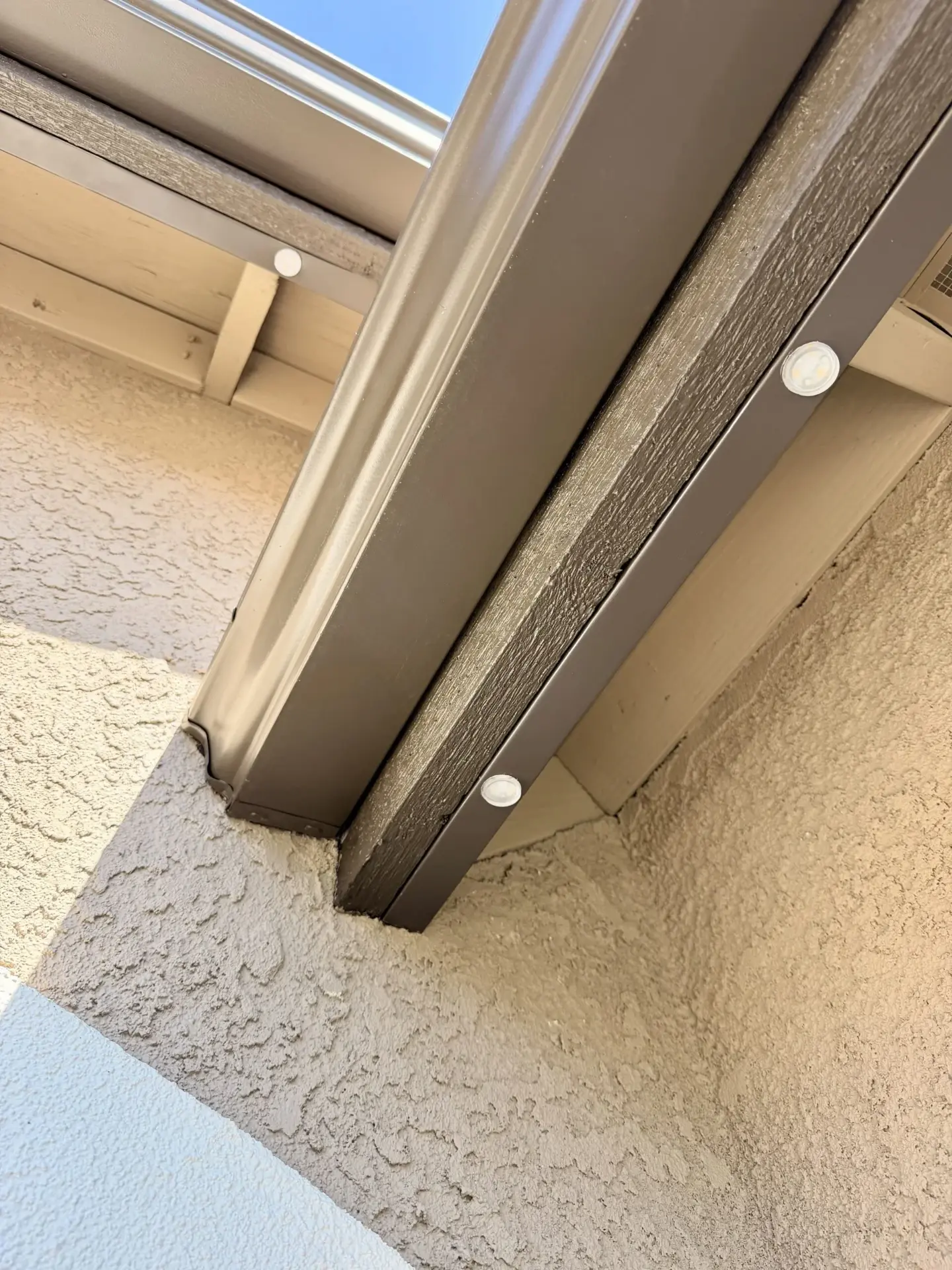 Close-up of hidden low voltage wiring routed behind the eave